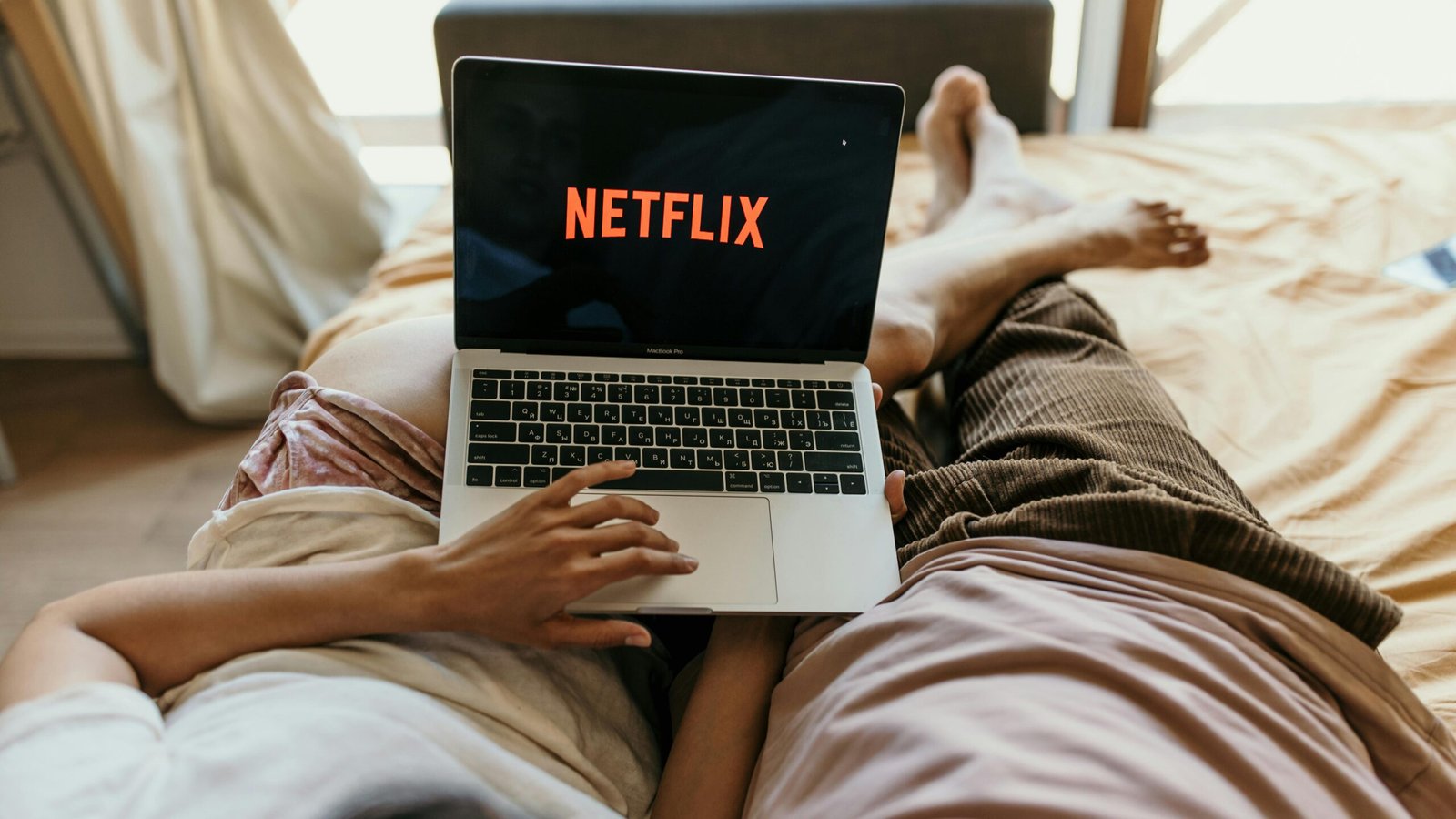 Photo by Anastasia Shuraeva: https://www.pexels.com/photo/a-couple-lying-on-bed-watching-netflix-on-a-laptop-4406681/
